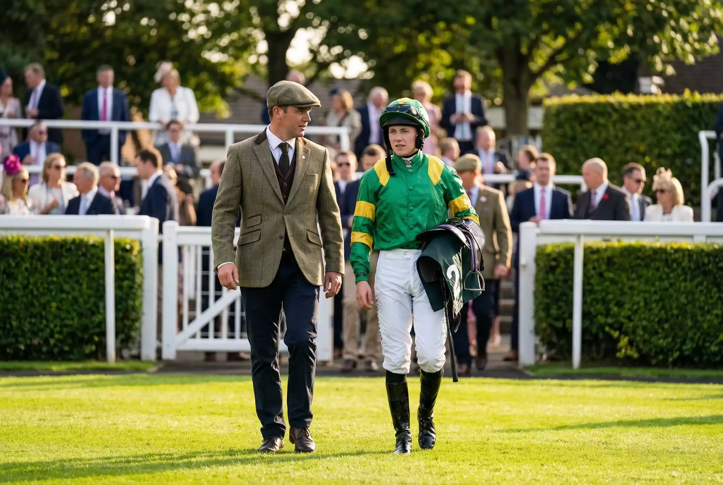 Trainer and jockey walking through the Goodwood parade ring before a race